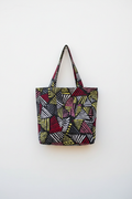The Zaina (Geometric) tote bag hanging on a white wall