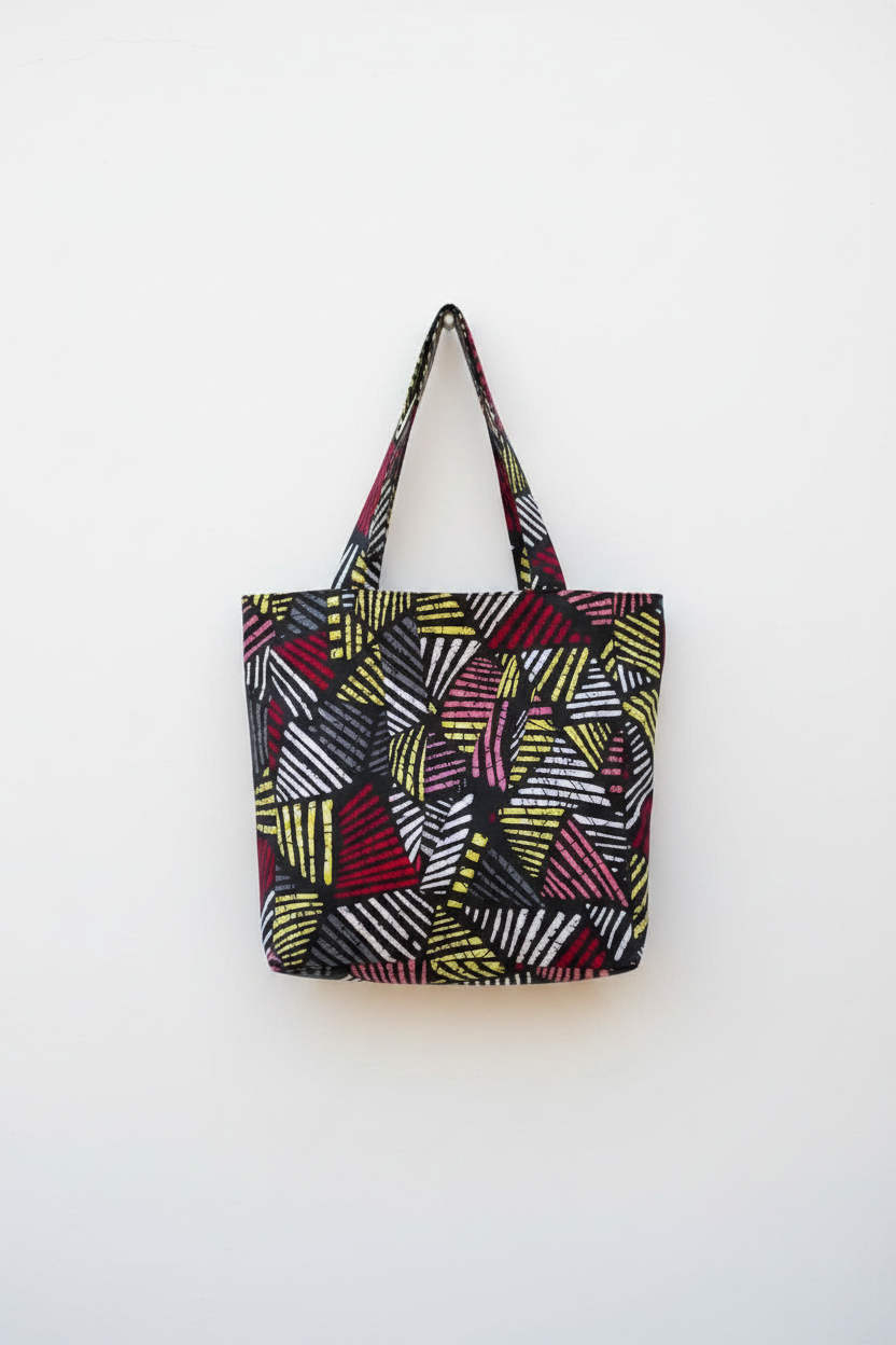 The Zaina (Geometric) tote bag hanging on a white wall